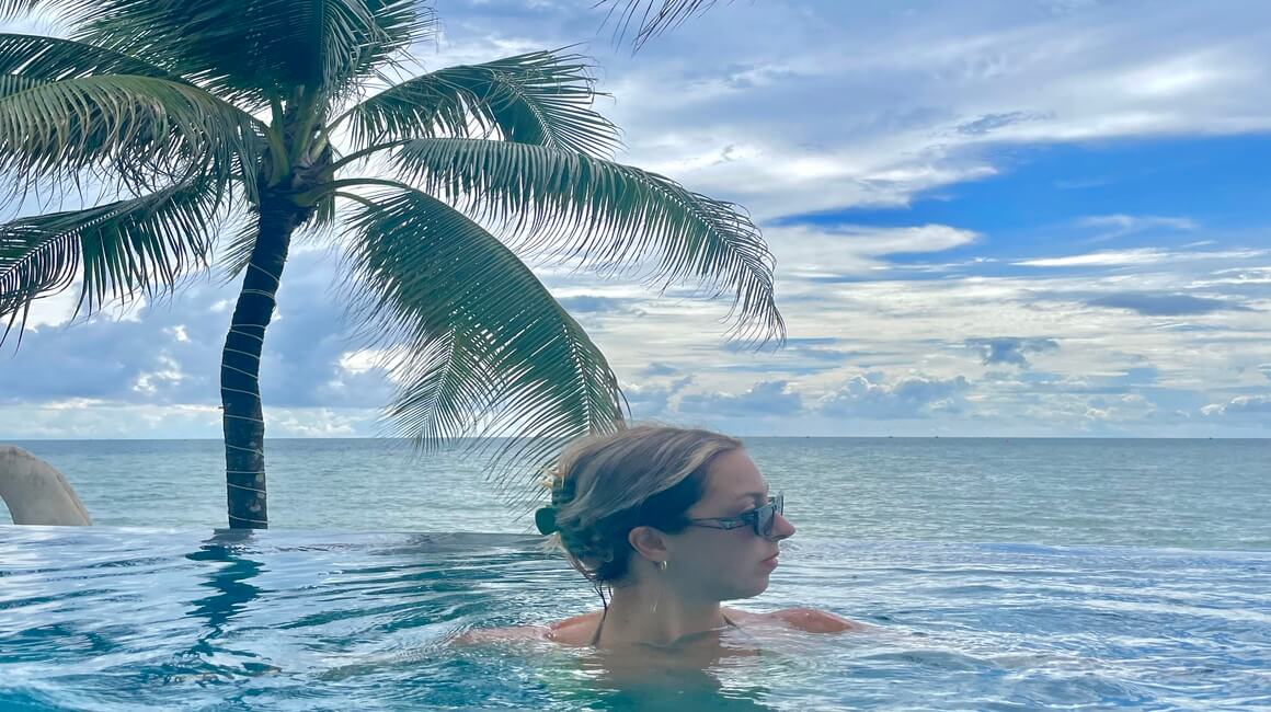 A woman looking off into the distance in an infinity pool in Phu Quoc