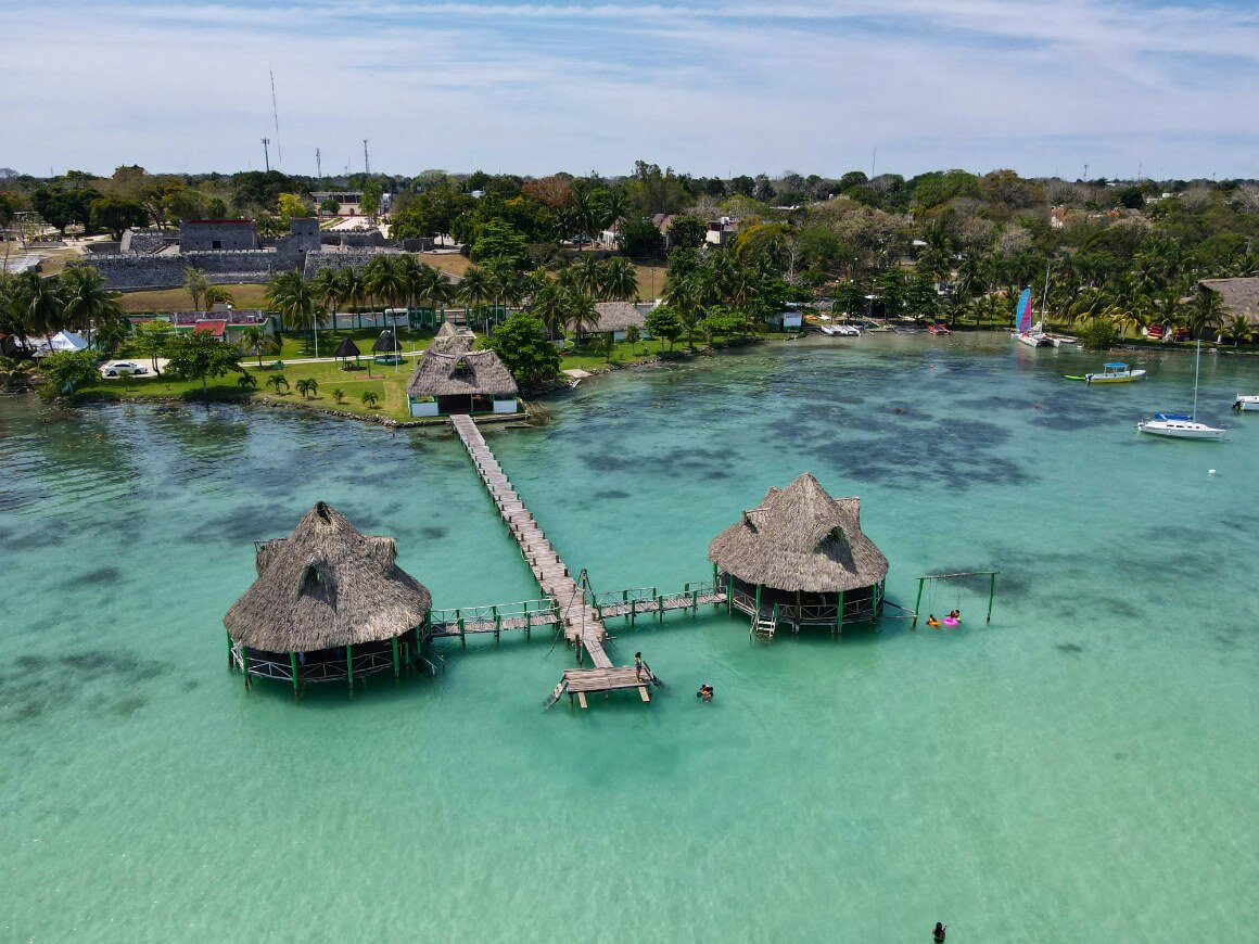 lagoon huts and wharf over the blue water of the lagoon Outside City center Bacalar