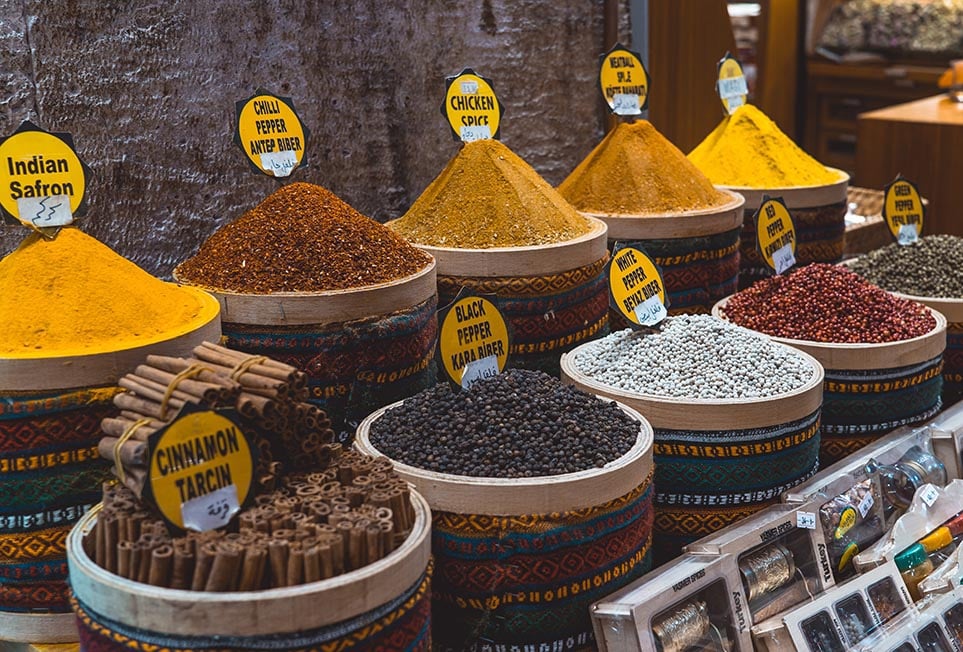 Several piles of spices and peppers at a spice souk in the middle east