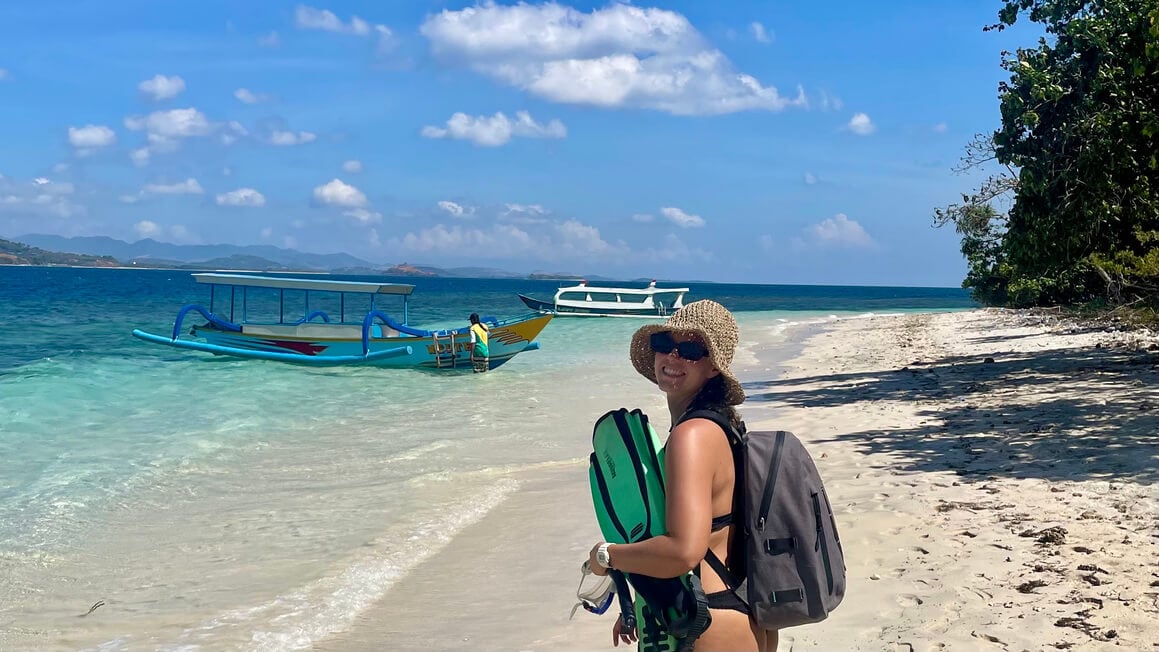 dani with her fins and snorkel at the secret gilis in lombok, indonesia