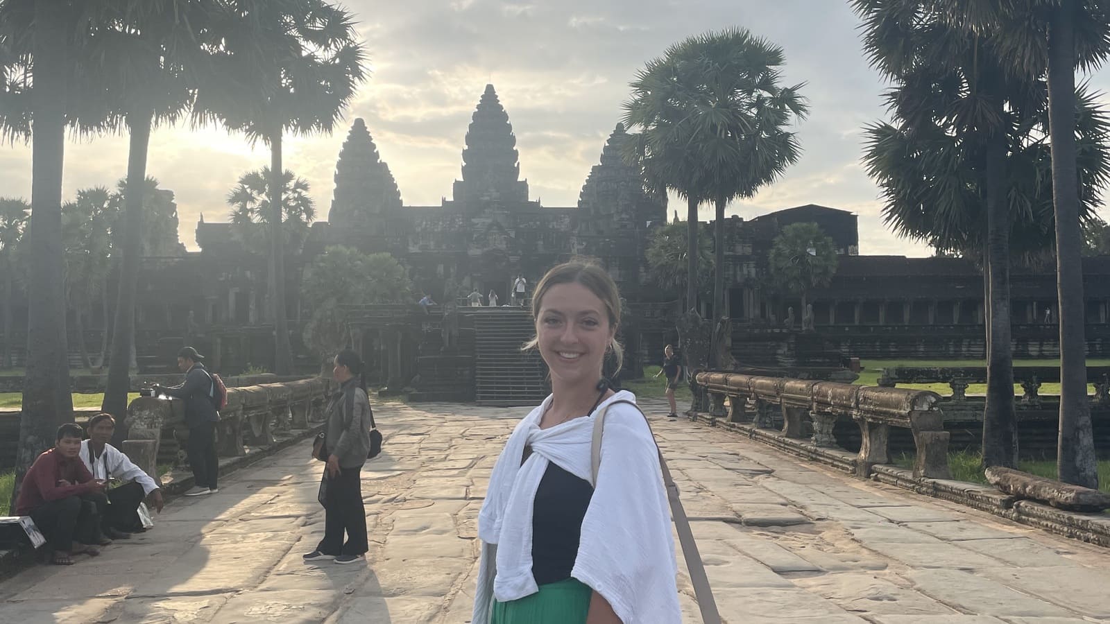 girl posing in front of angkor wat, cambodia at sunrise