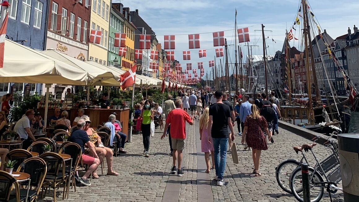 Danish Flags and colourful streets of Nyhavn, Copenhagen in Denmark