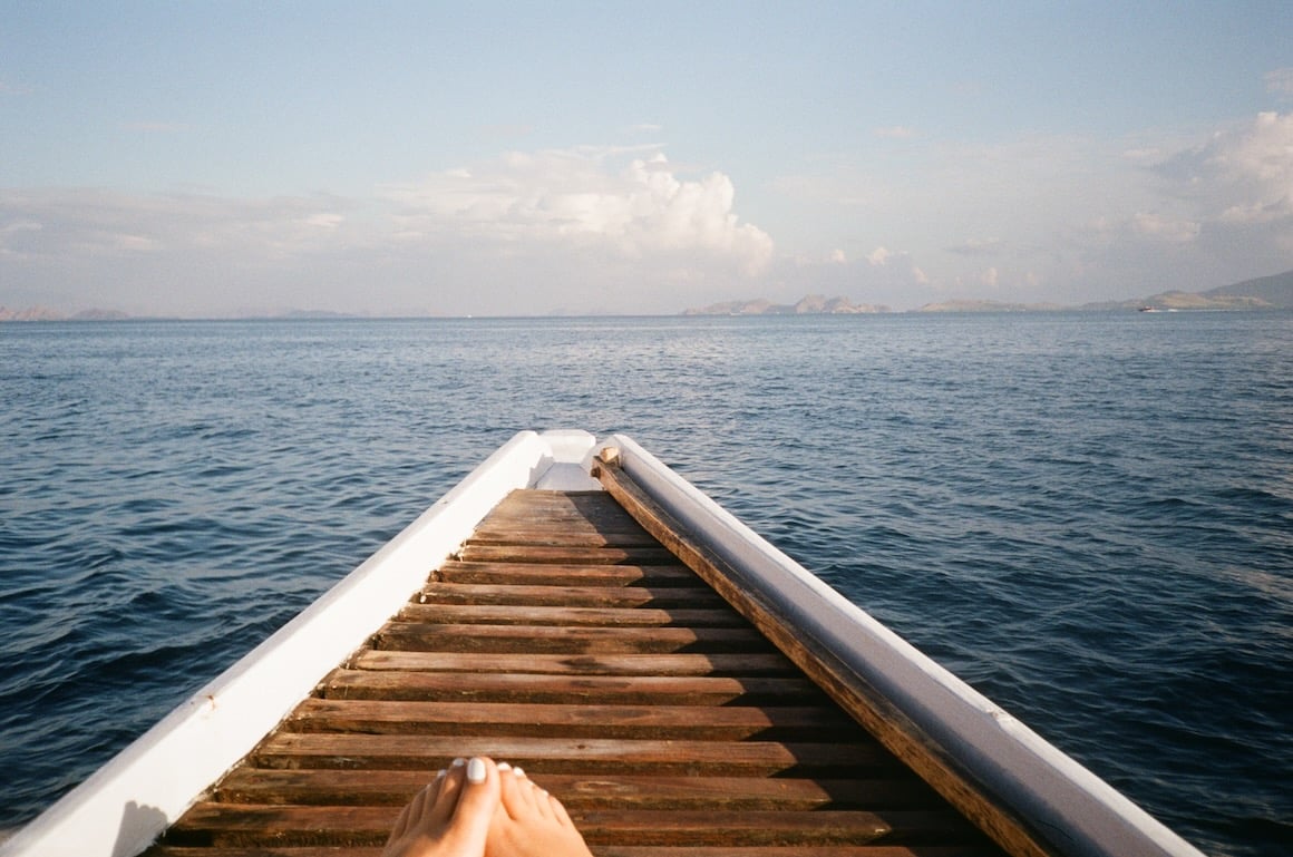 Relaxing on a dive boat out at sea in Nusa Penida, Bali Indonesia.