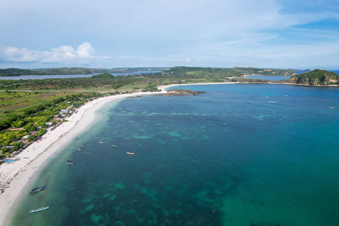 drone shot of tanjung aan beach and sea in lombok a long flat bay that stretches out for miles