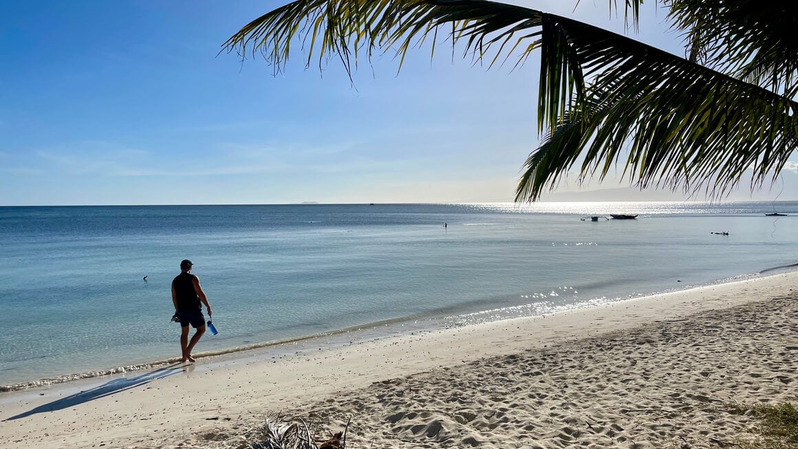 harv walking along a beach in the philippines