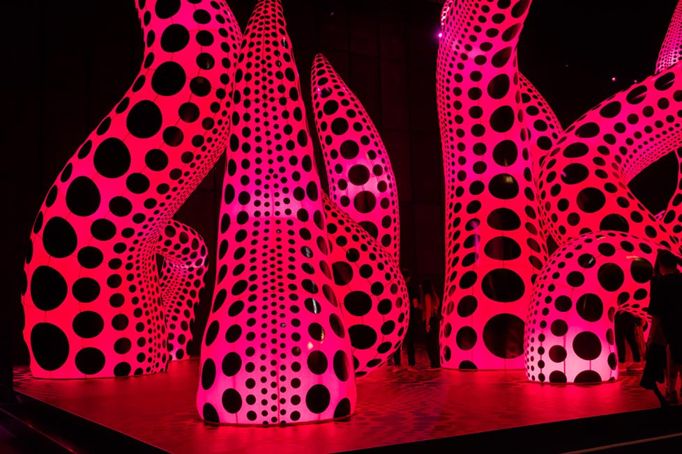 A exhibition by Yayoi Kusama at Factory International in Manchester, England, United Kingdom. It shows a collection of massive pink balloons with black polka dots in the shape of tentacles.