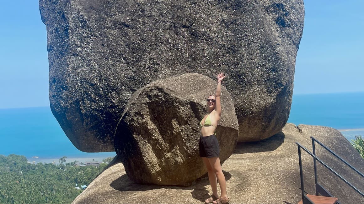 girl posing in front of overlapping stone, koh samui