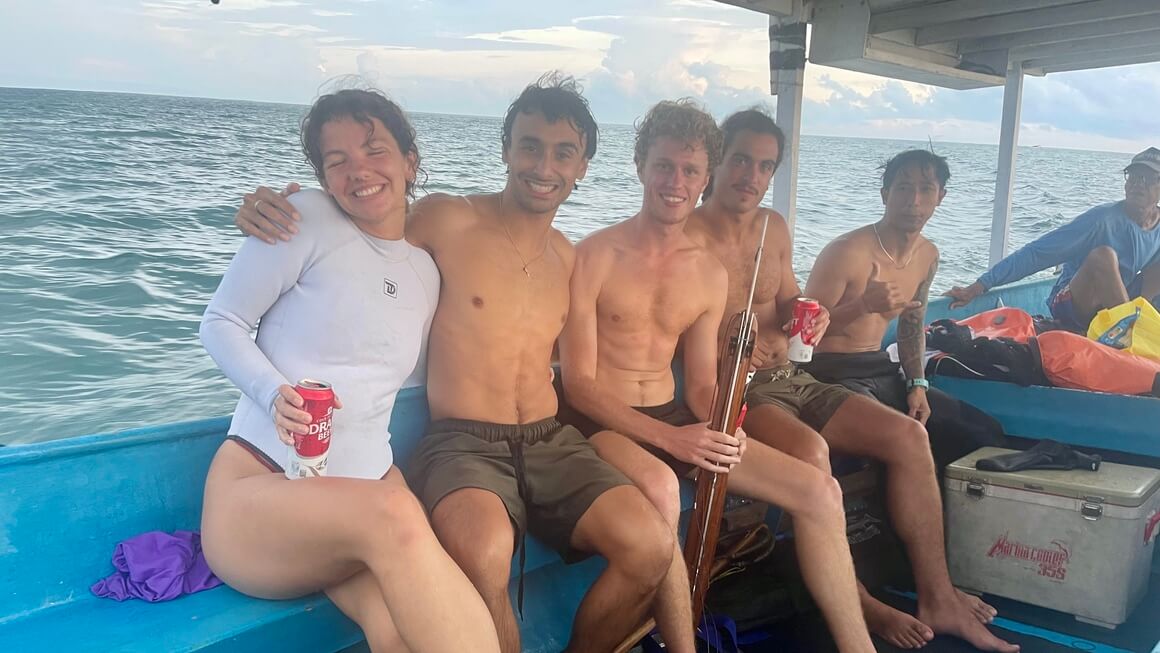 audy and friends on a boat in bali after spearfishing/ freediving