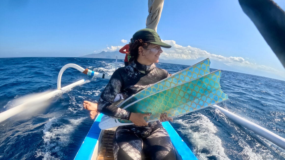 Audy on a boat with fins about to go freediving/ spearfishing in Bali