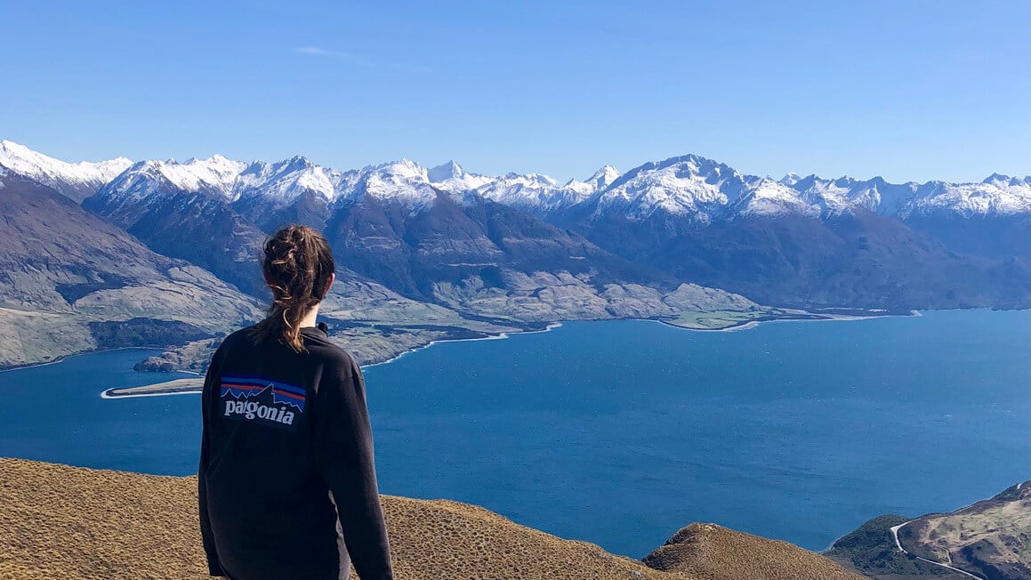 dani gazing over mountains from the summit of isthmus peak