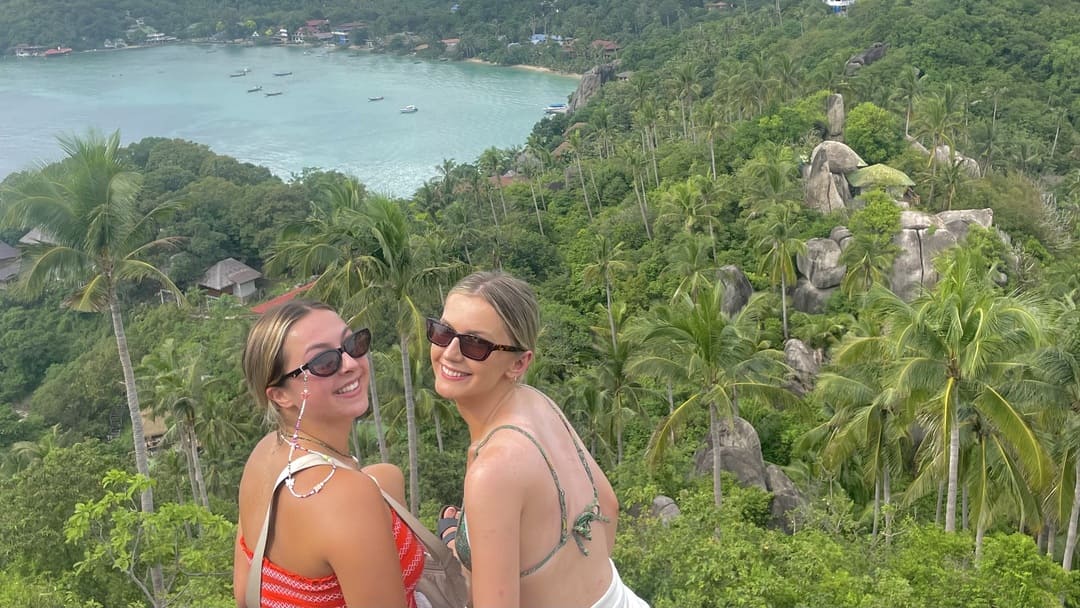 two girls smiling at john suwan viewpoint in koh tao, thailand