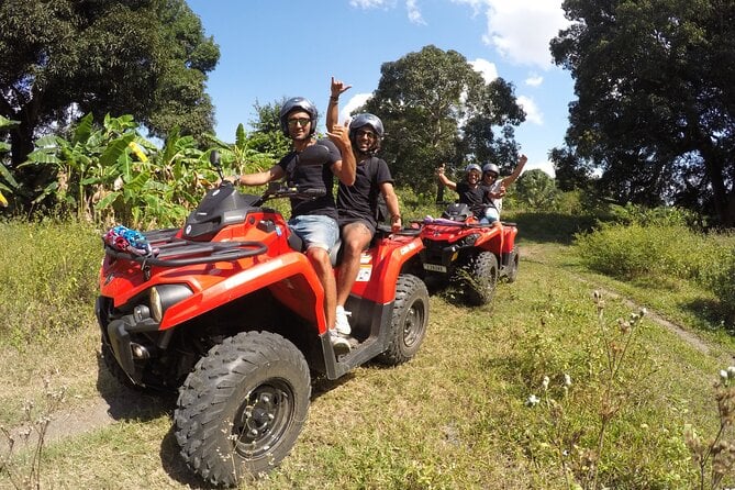 Four excited travellers on two quadbikes