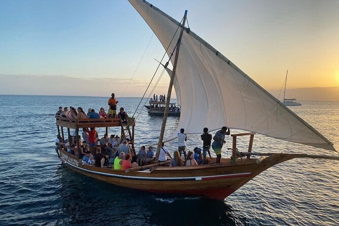 A group of people Sailing on a Traditional Dhow at Sunset, Zanzibar