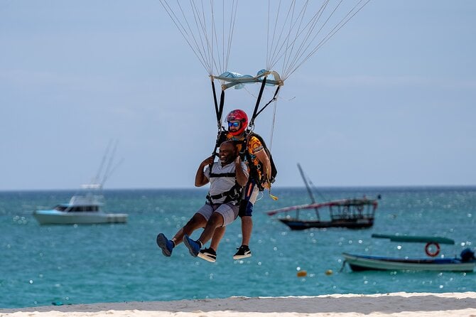 a person doing a Tandem Skydiving Experience in zanzibar, landing by the sea