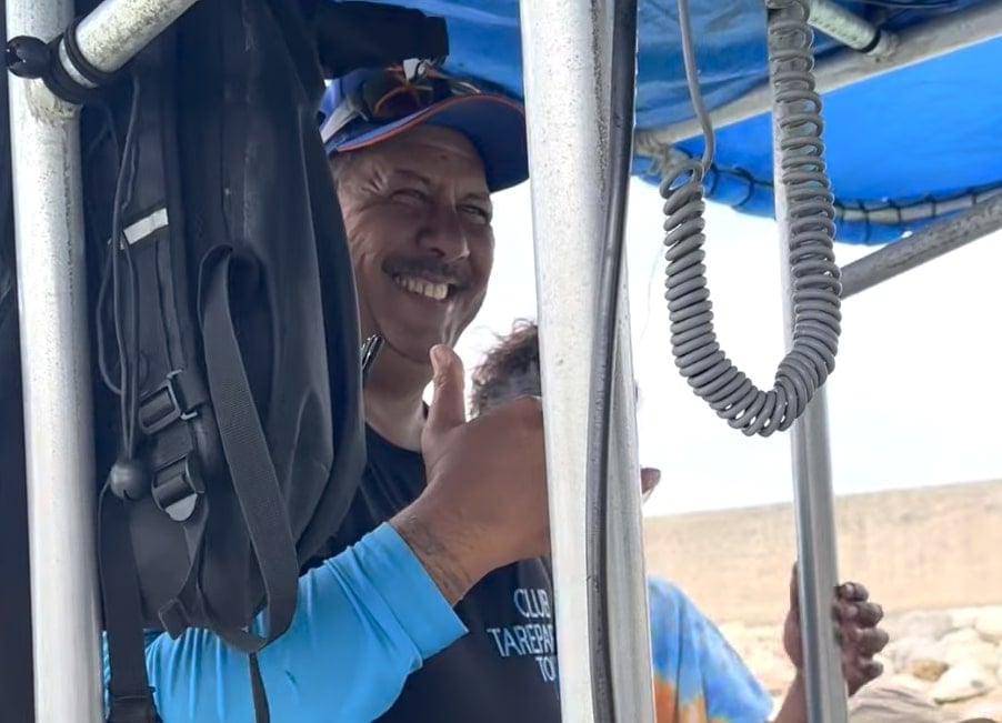 a local boat captain laughing while seeing rurutu whales in french polynesia