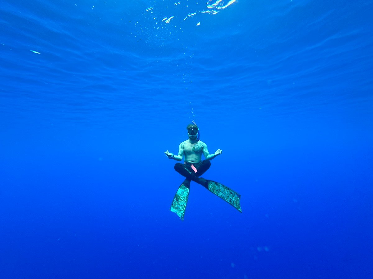 will freediving in french polynesia while holding a yoga meditation pose