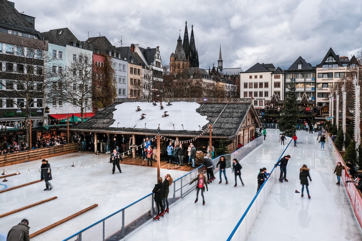 people ice skating on a cloudy day at the cologne christmas market