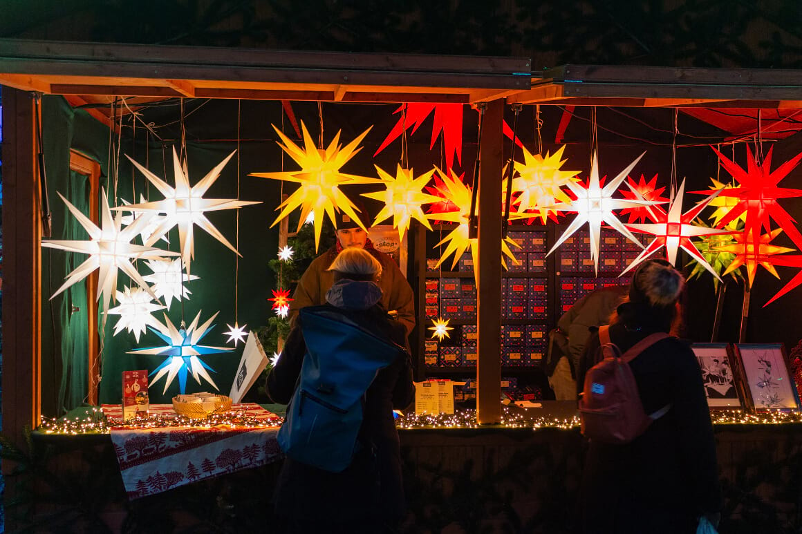 a person buyina christmas souvenir at the freiburg christmas market in germany 