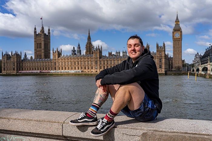 nic sitting by the river with big ben behind