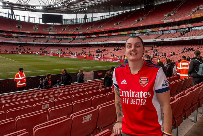 nic at a football staium wearing a football shirt