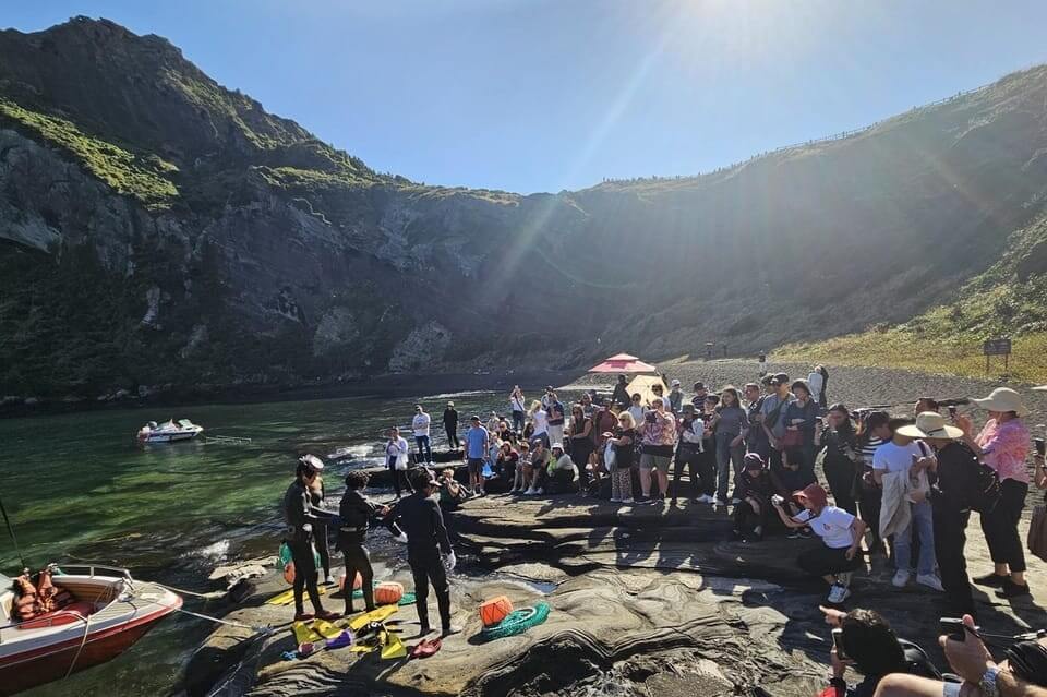 Tourists sightseeing and diving at Seongeup Folk Village