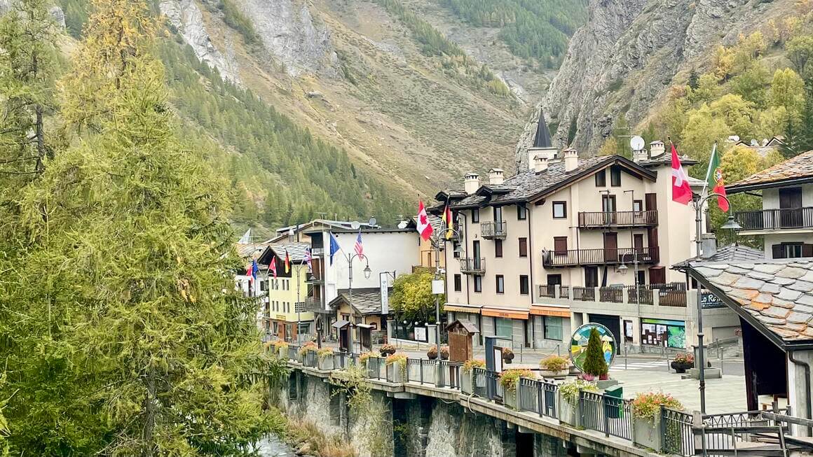 Small ski town in Italy with world flags and beautiful green landscapes.