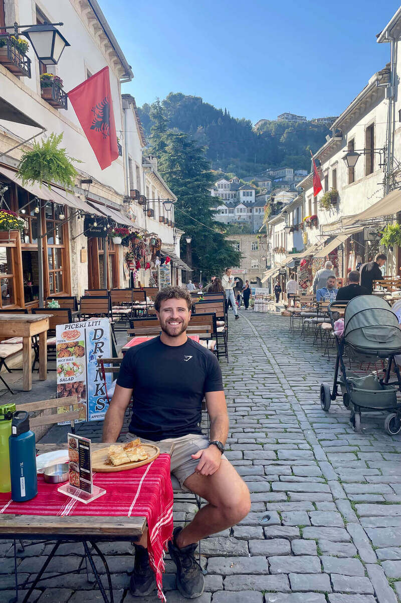 harv sitting in the old town in gjirokaster, albania