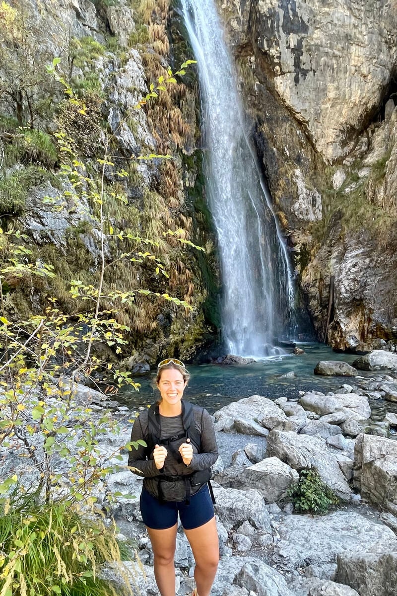 dani at grunas waterfall in theth, albania