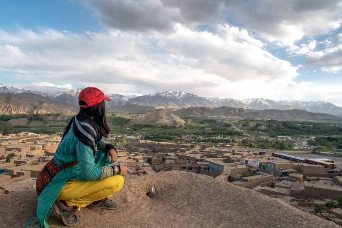 backpacker looks at mountains in the horizon while travelling in afghanistan