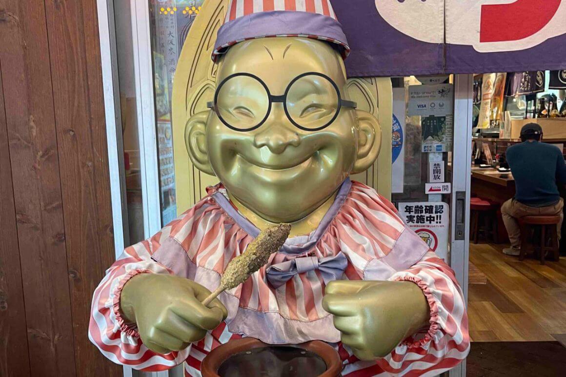 A smiling statue on the streets of Osaka, Japan.