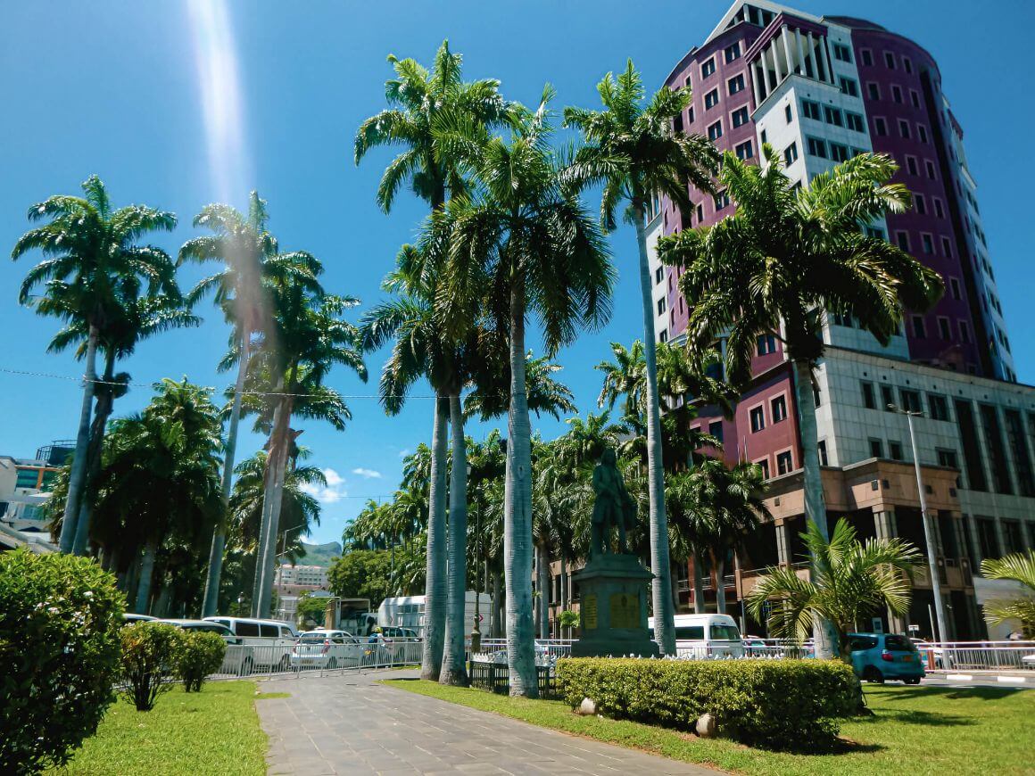 Statue and street in Port Louis - capital city of Mauritius