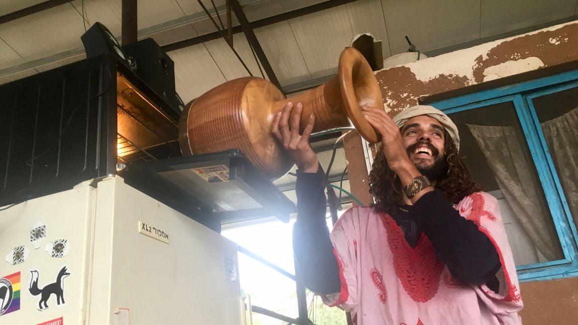 farm hippie holding a drum into the heat