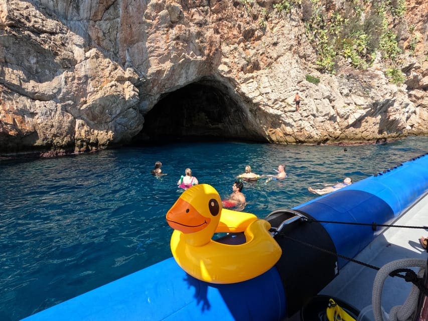 people snorkeling in blue water on a Male Caves Boat and Snorkelling Tour Monaco