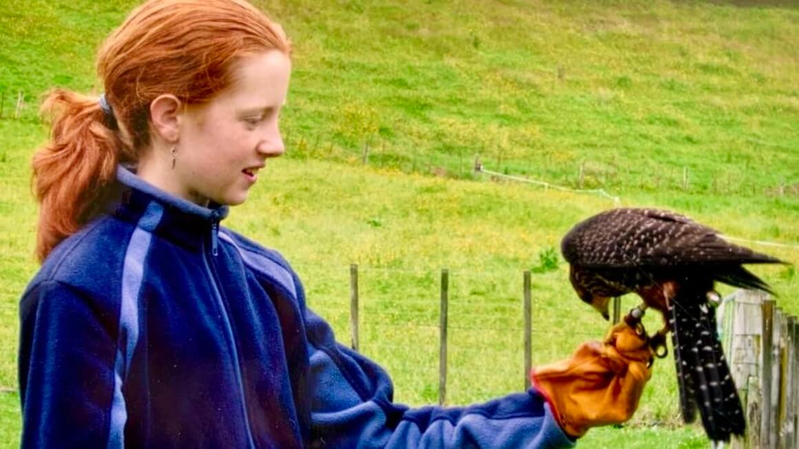 Maria in Rotorua with a native falcon at Wingspan, New Zealand