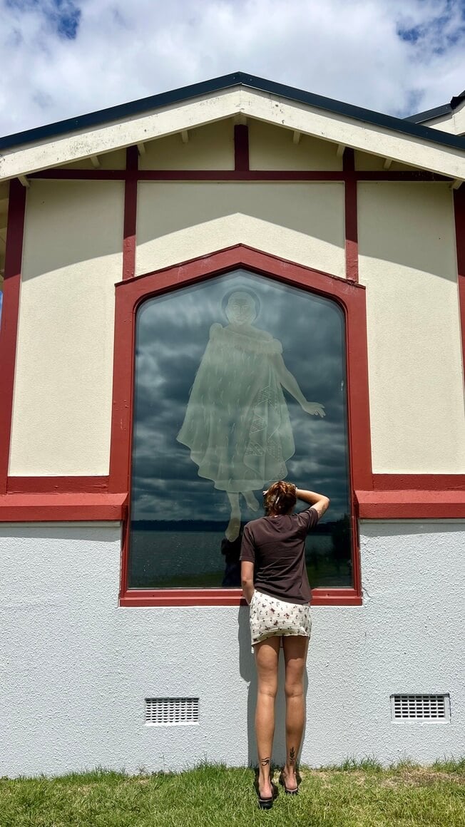 Maria looking in the church window at Rotorua, New Zealand