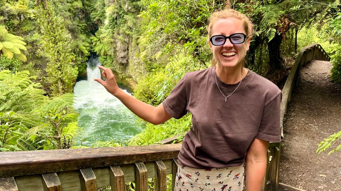 Maria laughing taking a tourist spec picture at Tuatea Falls Okere Falls Rotorua New Zealand