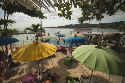 colorful beach umbrellas and a small in ground pool at a beach club in nusa lembongan indonesia