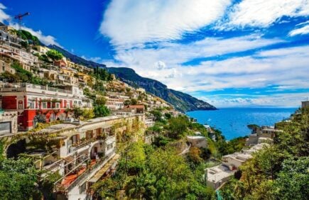 colourful houses on the cliffs in Sorrento amalfi coast with view over the sea in the distance