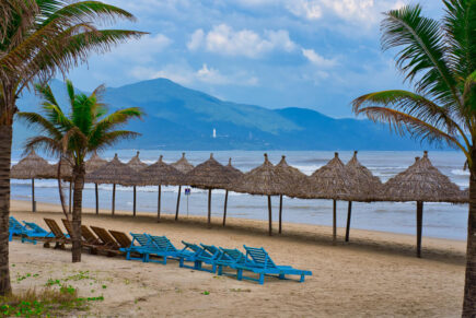 Beach chairs and umbrellas line the seashore at My Khe Beach, Da Nang.