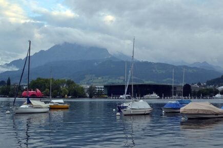 Cloud covered mountains with Lake Lucerne in the foreground in Lucerne, Switzerland