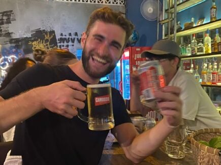 guy posing with cambodia beer in a bar