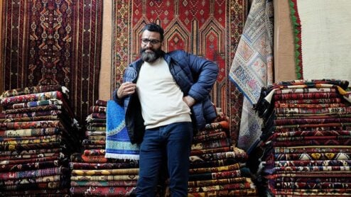 carpet seller at a bazaar in tehran, iran