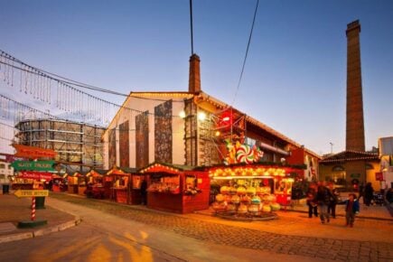 Colourful streets of Gazi with bright lights and carnival activities at sundown.